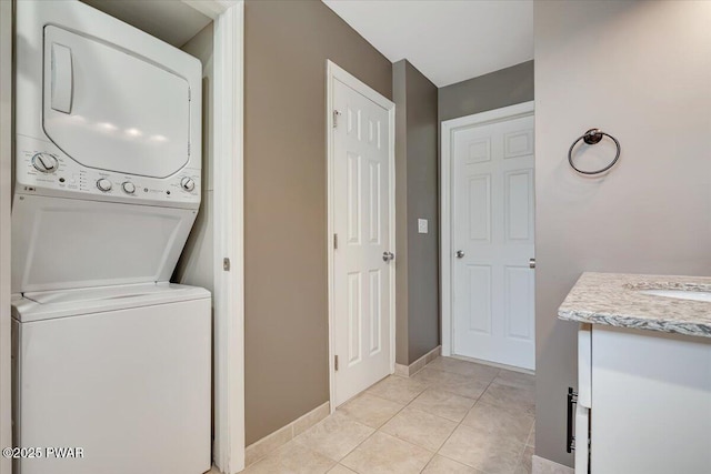 134 Laurel Hill Dr Unit 102, Greentown, PA 18426 - clothes washing area with laundry area, light tile patterned floors, a sink, baseboards, and stacked washer / drying machine