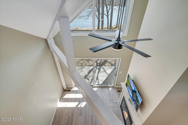 134 Laurel Hill Dr Unit 102, Greentown, PA 18426 - details with baseboards, a ceiling fan, a glass covered fireplace, and wood finished floors