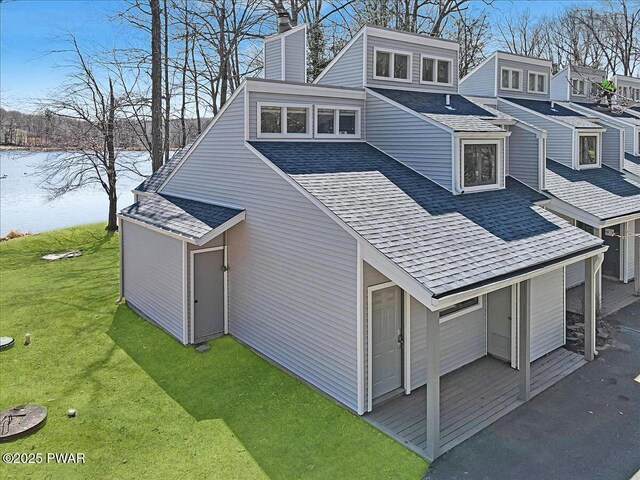 134 Laurel Hill Dr Unit 102, Greentown, PA 18426 - view of property exterior featuring roof with shingles, a chimney, a water view, and a yard