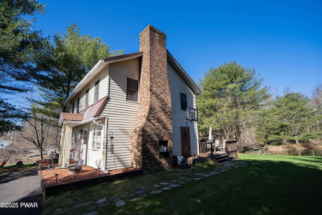 477 Purdytown Tpke, Lakeville, PA 18438 - view of side of home with a deck, a chimney, and a lawn