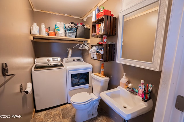 477 Purdytown Tpke, Lakeville, PA 18438 - laundry room with laundry area, stone finish floor, a sink, and washer and clothes dryer