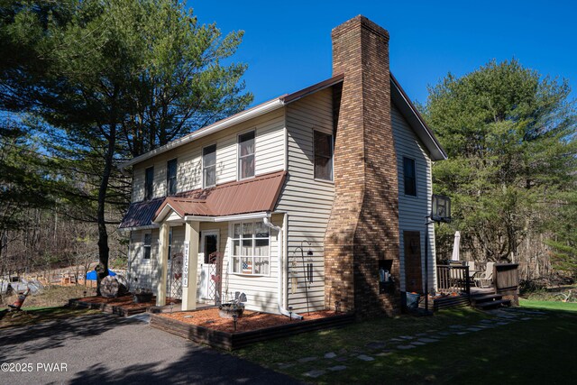 477 Purdytown Tpke, Lakeville, PA 18438 - view of front of home with a chimney, metal roof, a front yard, and a wooden deck