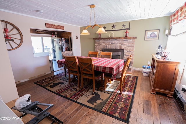 477 Purdytown Tpke, Lakeville, PA 18438 - dining area with hardwood / wood-style floors, wooden ceiling, a fireplace, and ornamental molding