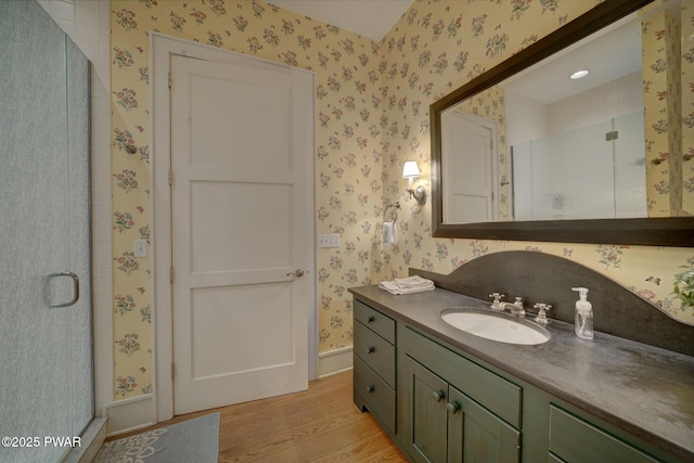 130 Calico Ct, Paupack, PA 18451 - full bath featuring a stall shower, wood finished floors, vanity, and wallpapered walls