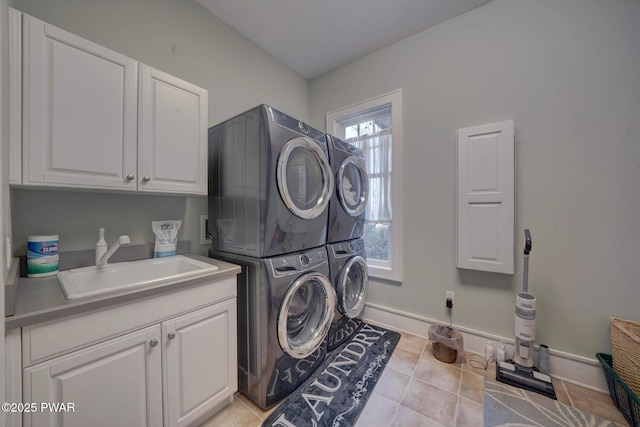 130 Calico Ct, Paupack, PA 18451 - laundry area with stacked washer and dryer, a sink, cabinet space, light tile patterned floors, and baseboards