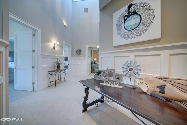 130 Calico Ct, Paupack, PA 18451 - office with visible vents, carpet, a high ceiling, wainscoting, and a decorative wall