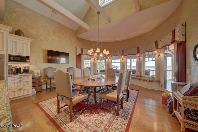 130 Calico Ct, Paupack, PA 18451 - dining area featuring high vaulted ceiling, an inviting chandelier, and light wood-style flooring