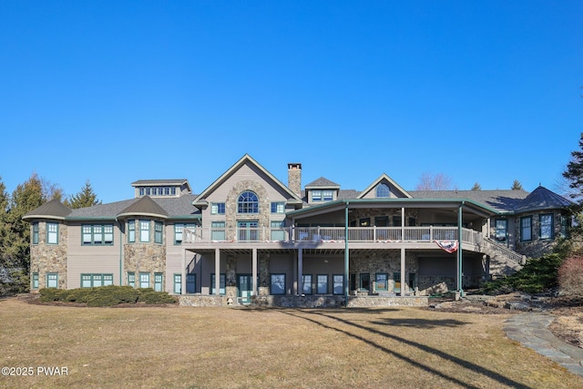 130 Calico Ct, Paupack, PA 18451 - back of property featuring stone siding, a lawn, and a chimney