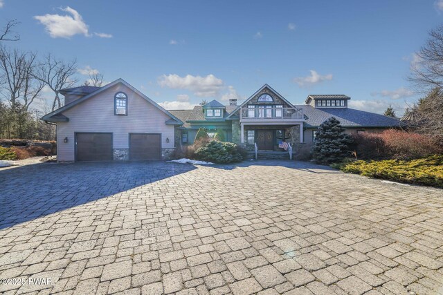 130 Calico Ct, Paupack, PA 18451 - view of front of home featuring decorative driveway, stone siding, and roof with shingles