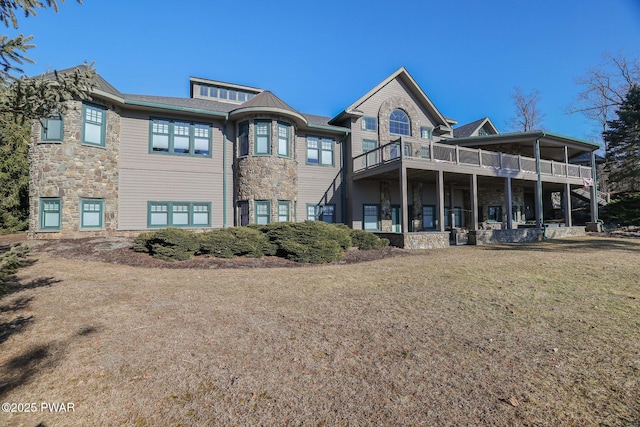 130 Calico Ct, Paupack, PA 18451 - back of property with a balcony, a lawn, and stone siding