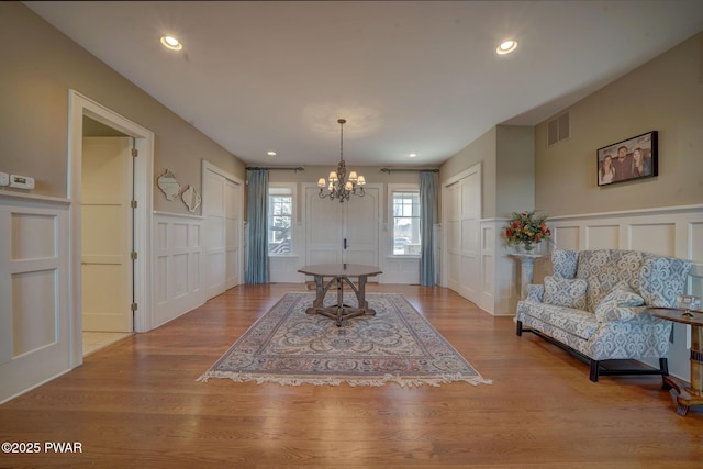 130 Calico Ct, Paupack, PA 18451 - dining area featuring a decorative wall, a notable chandelier, wood finished floors, and visible vents