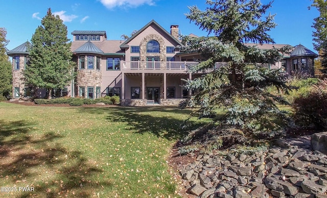 130 Calico Ct, Paupack, PA 18451 - rear view of house featuring a lawn, stone siding, and a chimney