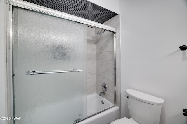 full bathroom with enclosed tub / shower combo and toilet