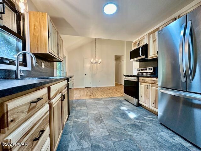 106 Rodeo Ln, Lords Valley, PA 18428 - kitchen featuring stainless steel appliances, dark countertops, a chandelier, backsplash, and pendant lighting