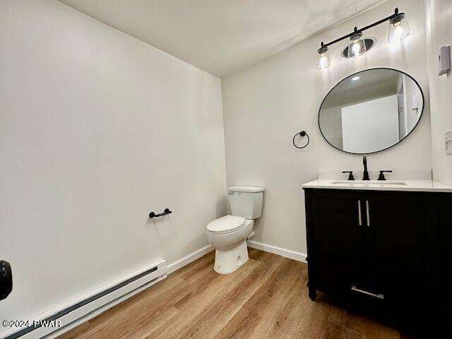 106 Rodeo Ln, Lords Valley, PA 18428 - bathroom featuring a baseboard heating unit, wood finished floors, and vanity