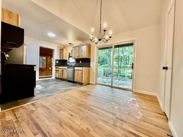 kitchen featuring an inviting chandelier, decorative light fixtures, stainless steel dishwasher, and light hardwood / wood-style flooring