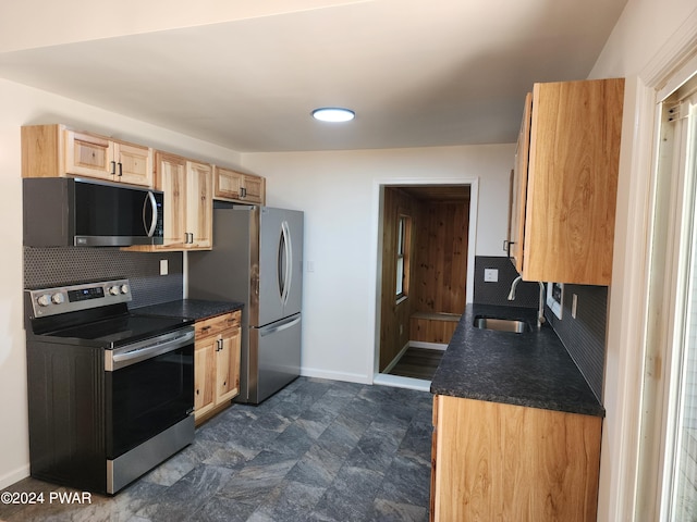 kitchen with tasteful backsplash, light brown cabinetry, sink, and appliances with stainless steel finishes