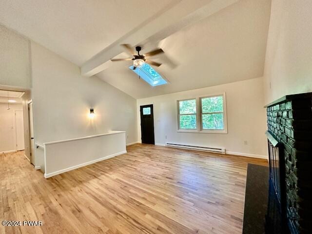 unfurnished living room featuring vaulted ceiling with beams, baseboard heating, and light hardwood / wood-style flooring