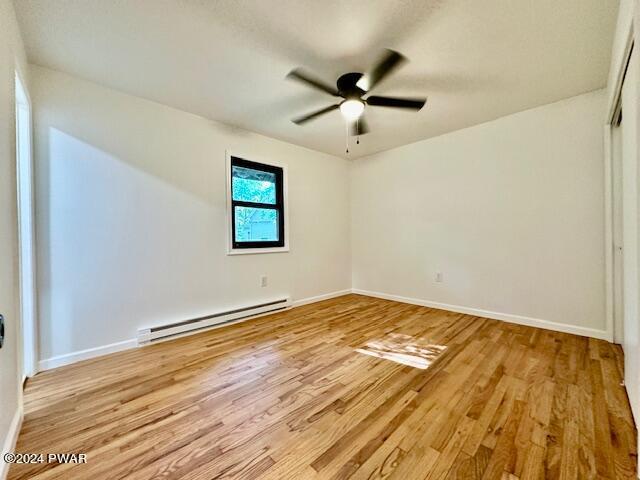 106 Rodeo Ln, Lords Valley, PA 18428 - unfurnished room with baseboard heating, light wood-style flooring, and ceiling fan