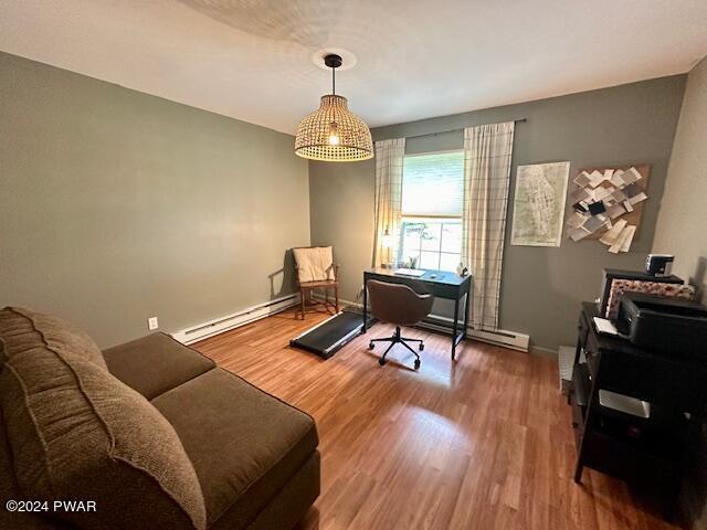 office area featuring hardwood / wood-style flooring and a baseboard heating unit