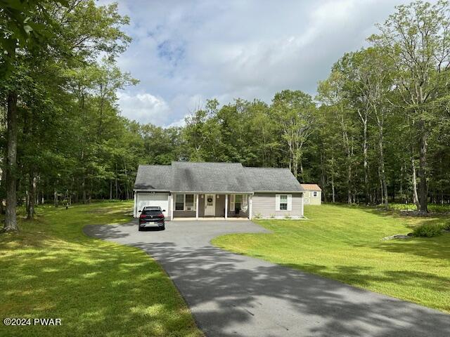 view of front of house with a front yard and a garage