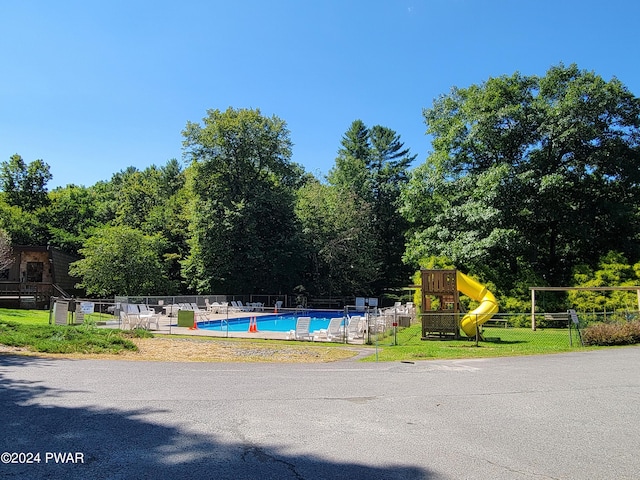 view of pool with a playground