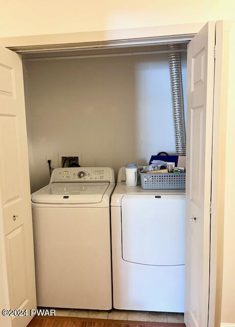 clothes washing area with washer and dryer