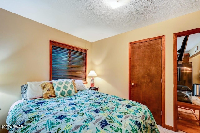 carpeted bedroom with a textured ceiling