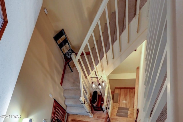 stairway featuring a towering ceiling