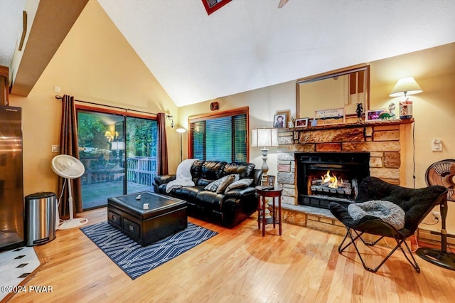 living room with a fireplace, high vaulted ceiling, and hardwood / wood-style flooring