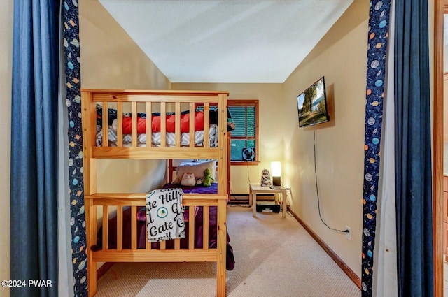 bedroom with carpet floors and vaulted ceiling