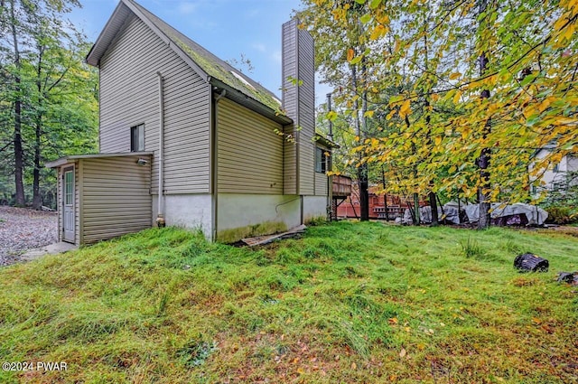 view of property exterior with a yard