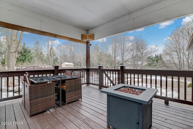 wooden terrace with a fire pit