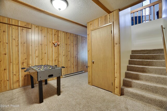 1706 Windemere Ct, Lake Ariel, PA 18436 - recreation room featuring carpet, wood walls, a textured ceiling, and a baseboard radiator