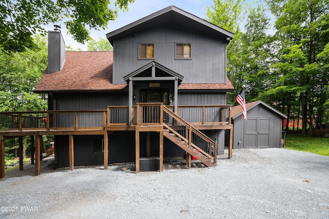1706 Windemere Ct, Lake Ariel, PA 18436 - chalet / cabin with a storage shed, a chimney, roof with shingles, a wooden deck, and stairs