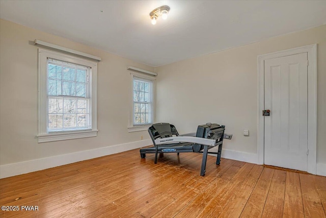 living area with baseboards and light wood-style flooring
