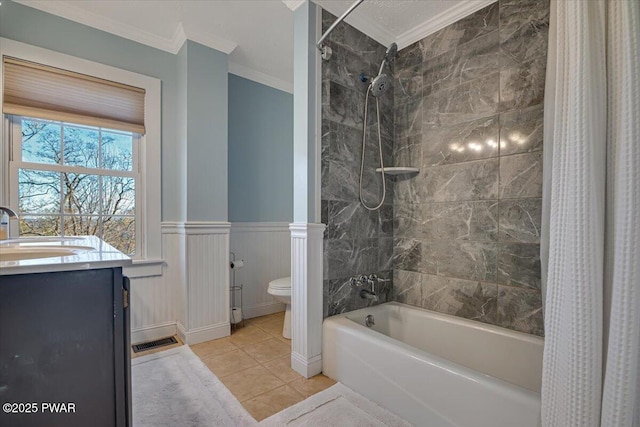 bathroom featuring toilet, a wainscoted wall, shower / tub combo with curtain, crown molding, and vanity