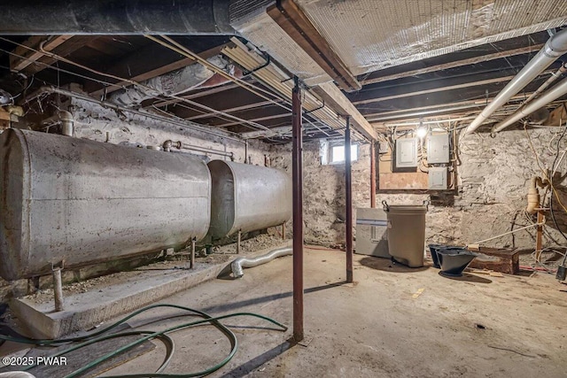 basement featuring electric panel and heating fuel