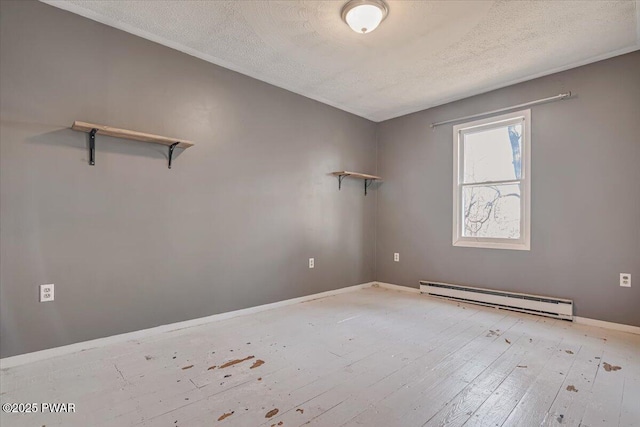 empty room featuring a baseboard radiator, a textured ceiling, baseboards, and light wood-style flooring