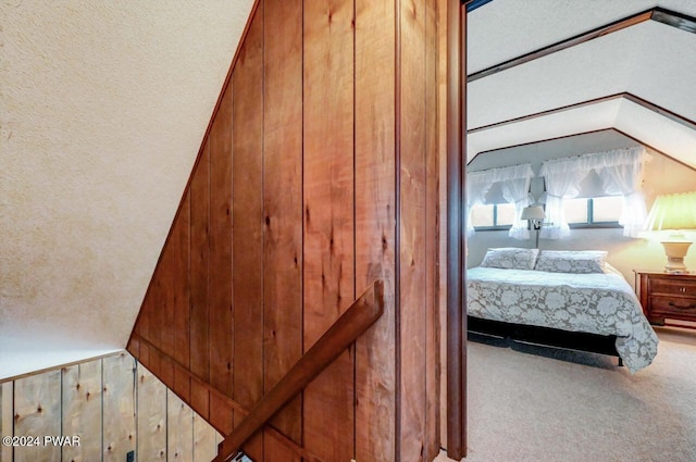 interior space with carpet flooring and wood walls