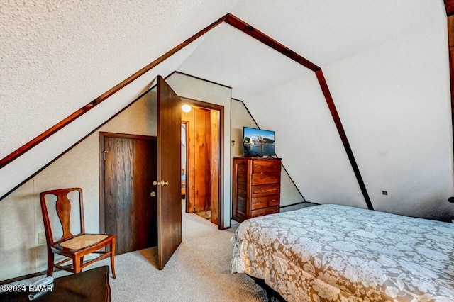 carpeted bedroom featuring lofted ceiling