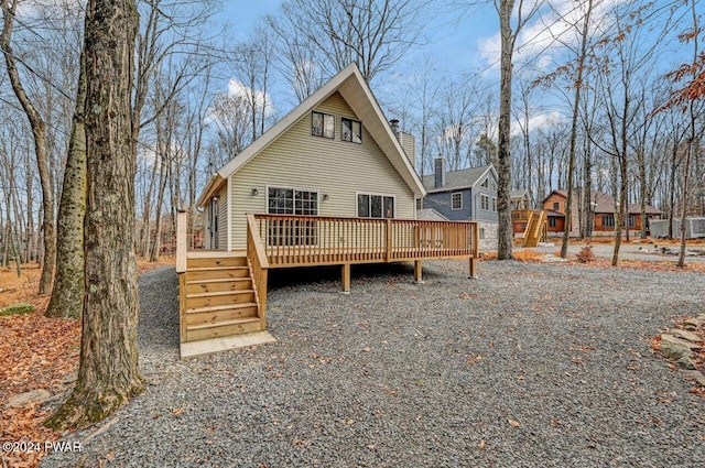 rear view of house featuring a deck