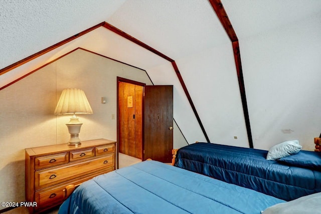 bedroom with lofted ceiling