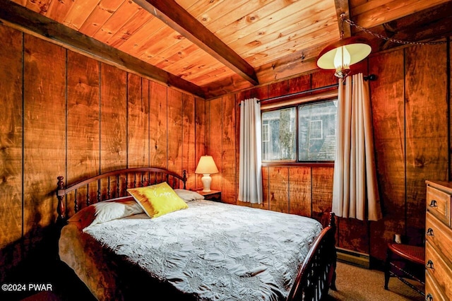 bedroom with beam ceiling, wooden walls, carpet floors, and wood ceiling