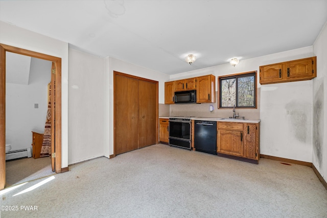 kitchen with brown cabinetry, a sink, light countertops, black appliances, and a baseboard heating unit