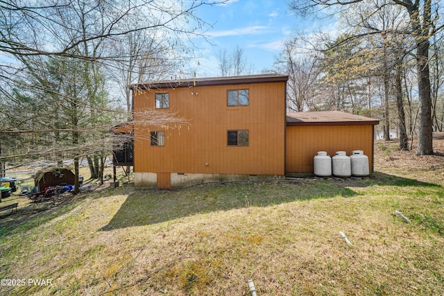rear view of house with a yard and crawl space
