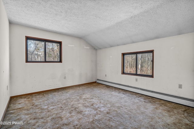 carpeted spare room featuring baseboards, a baseboard radiator, vaulted ceiling, and a textured ceiling