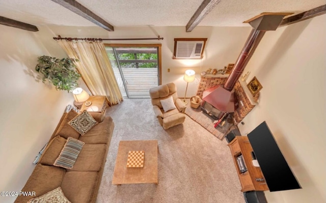 living room with carpet flooring, a wood stove, beam ceiling, and a textured ceiling