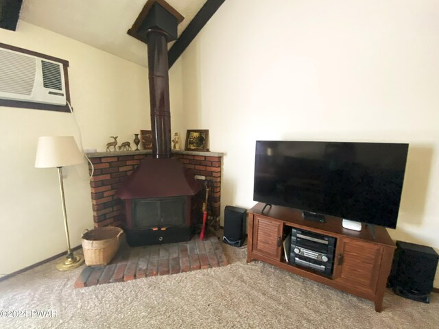 living room featuring a wood stove, carpet, and a wall mounted air conditioner