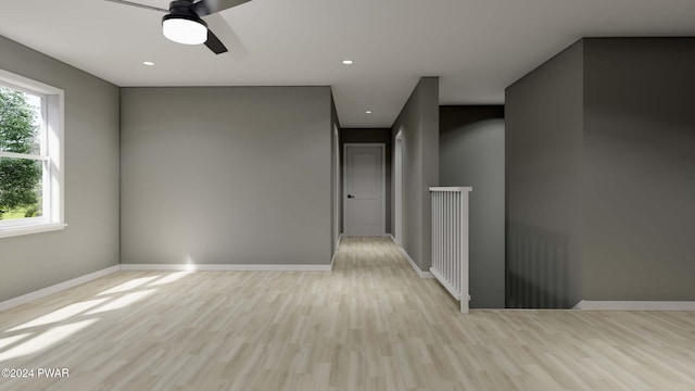 empty room with light hardwood / wood-style floors and ceiling fan